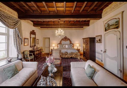 a living room with a bed and a couch at Castello di Casalborgone, Luxury Italian Castle Hotel in Casalborgone