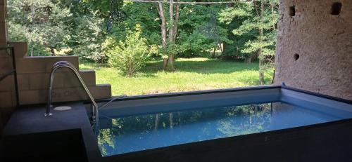a swimming pool with a view of a yard at Manoir La Cerise in Fougerolles