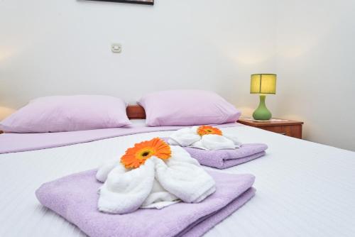 a bedroom with two beds with towels at Villa Zdenka in Pakoštane