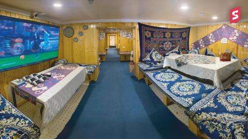 a train room with three beds and a video game at STARS University Dormitory in Tashkent