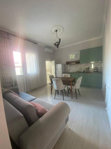 a living room with a couch and a table at Guest House Deme in K'obulet'i