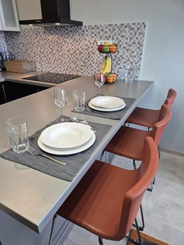 a table with two plates and wine glasses on it at D&D Studio Apartment in Velika Gorica