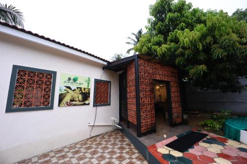 a house with a brick wall and a patio at coral beach resort in Mahabalipuram
