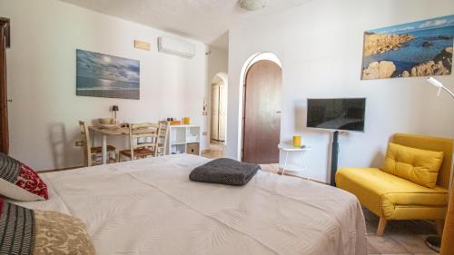 Una sala de estar con una cama y un comedor. en Domo Fadda Orosei, en Orosei