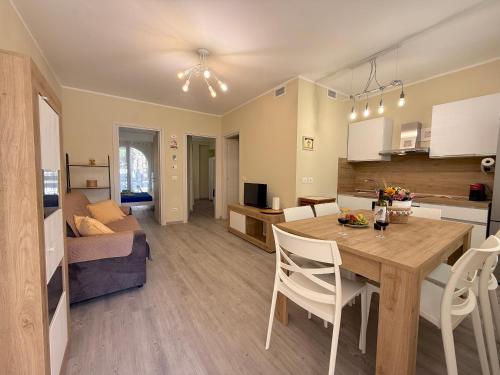 a kitchen and living room with a table and chairs at Borgo Del Navigatore in Marina di Grosseto