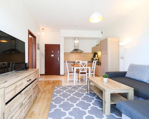 a living room with a couch and a table at Baltic Park Plaza by Baltic Home in Świnoujście
