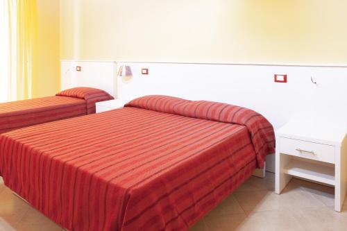 Postel nebo postele na pokoji v ubytování Stanza per 2 ospiti nel centro, a due passi dal mare - Il Mozzo!