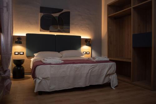a bedroom with a bed with two towels on it at Aurooms in Cinisi