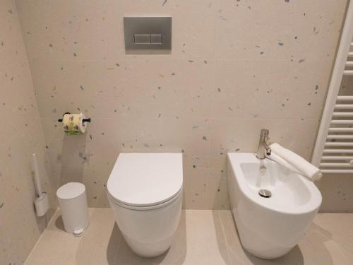 a bathroom with a white toilet and a sink at Domus Eterea in Marsala