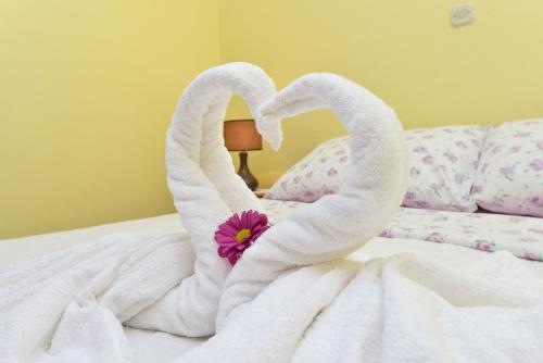 two swans made out of towels on a bed at Villa Zdenka in Pakoštane
