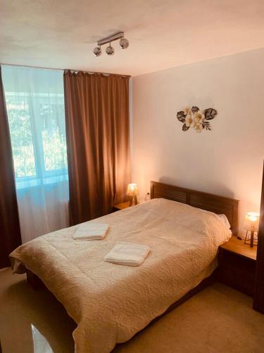 a bedroom with a bed with two towels on it at Cotroceni Prestigious in Bucharest