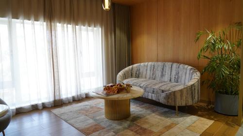 a living room with a chair and a table at Seasons Rajkot in Rajkot