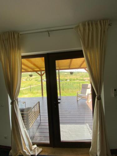 a sliding glass door leading to a deck at Tiny Shelter in Valea Fanatelor, Cluj Napoca in Cluj-Napoca