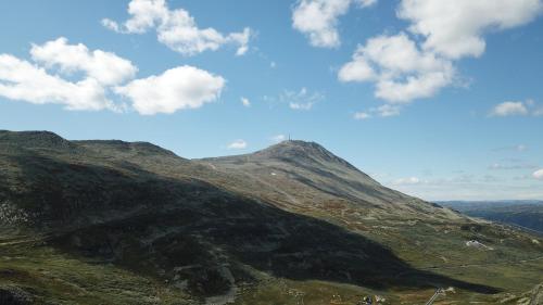 a view of a mountain with a blue sky and clouds at Gaustatoppen Hytteutleie in Gaustablikk
