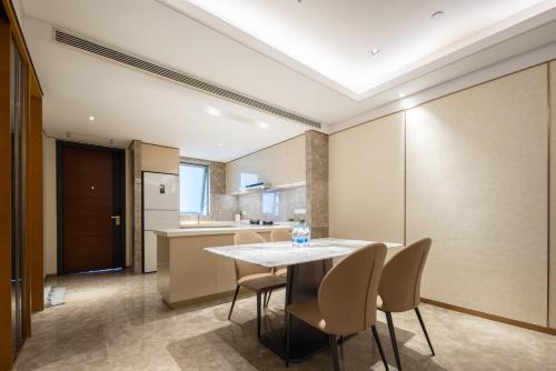 a dining room and kitchen with a table and chairs at Sanya Haitang Bay Ocean State International Resort Hotel in Sanya