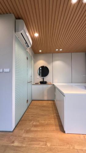 a room with white cabinets and a wooden ceiling at DSD Resort in Háº£i Háº­u