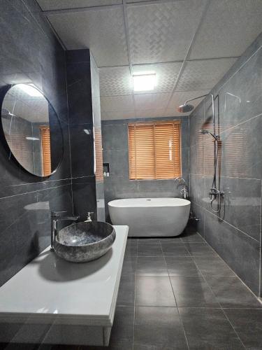 a bathroom with a sink and a bath tub at Lotus Hotel Ninh Bình in Ninh Binh