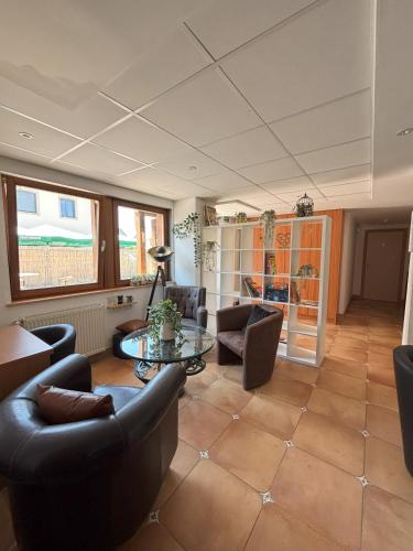 a living room with couches and a table at Chez Anabel et Stéphane in Battenheim