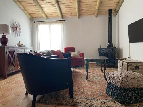 a living room with a couch and a fire place at Casa de la Cruz in Encinasola