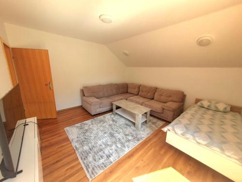 a living room with a couch and a table at Villa Nature in Hadžići