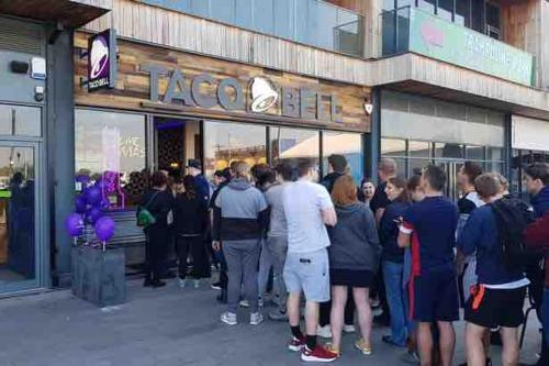 a crowd of people standing outside of a store at Amazing Location with Parking in Kent