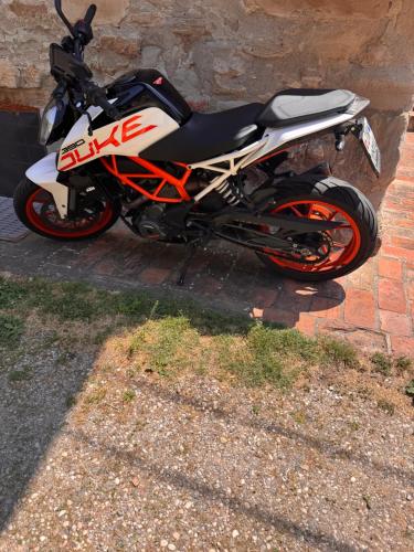 a motorcycle parked next to a brick wall at La corte dei celti -1 in San Benedetto Del Querceto