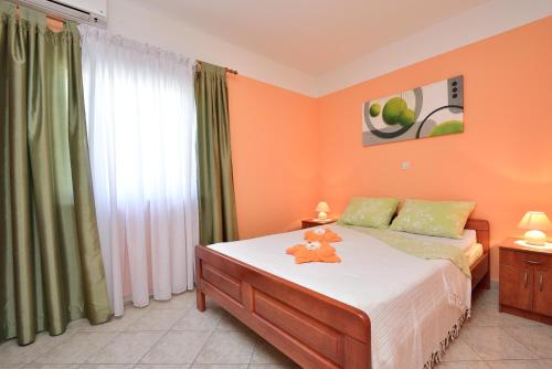 a bedroom with a bed and a large window at Villa Zdenka in Pakoštane