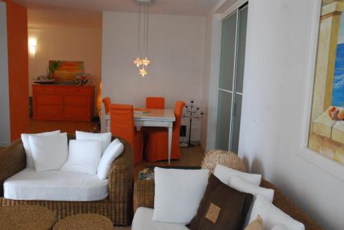 a living room with white chairs and a table at Heron apartments in Lido di Jesolo