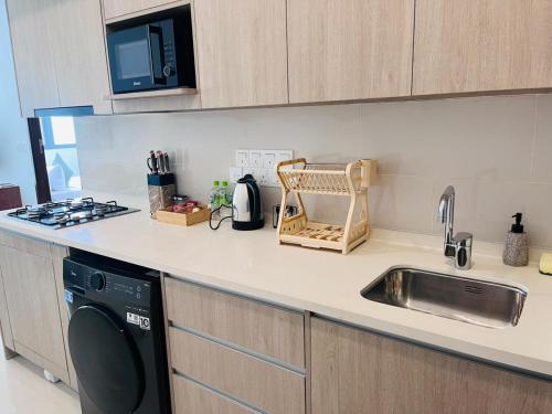 a kitchen counter with a sink and a dishwasher at Colombo, Trizen Luxury Apartments, Sri Lanka in Colombo