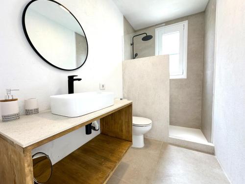 a bathroom with a sink and a mirror at Villa Ohana by Sonne Villas in Cala Galdana