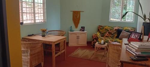a living room with a couch and a table at Blend Lodge and Kitchen in Zomba