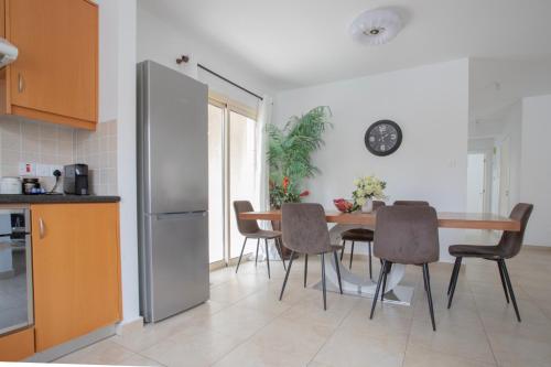 a kitchen and dining room with a table and chairs at Elysia Park Apartments in Paphos City