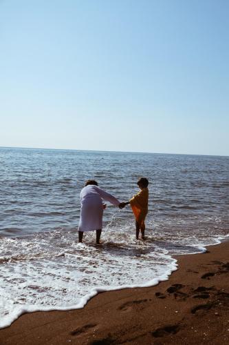 two people standing in the water at the beach at OXYGEN Shekvetili in Shekvetili