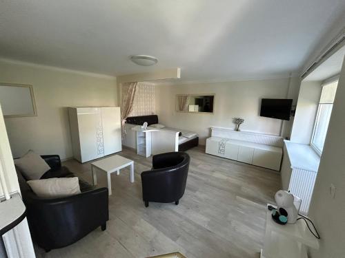 a living room with a couch and a table at Danės 5 apartament in Klaipėda