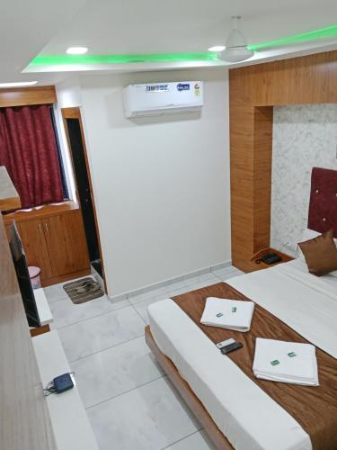 a room with a bed and a table in it at Hotel Metro AC Room in Vadodara