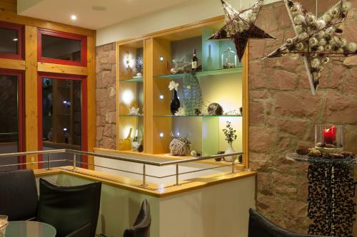 a room with a counter with vases on shelves at Haus Rebland Urlaubsglück-Hotel in Baden-Baden