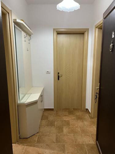 a bathroom with a door and a sink and a mirror at Al mare! 01 in Shëngjin
