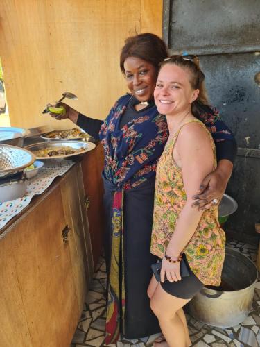 two women standing in a kitchen preparing food at Casa Djoko in Dakar