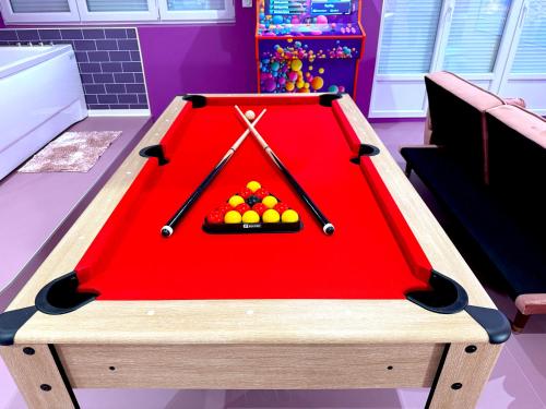 a red pool table with balls on top of it at Capsule Bubble Jacuzzi Sauna Switch 2 in Maubeuge