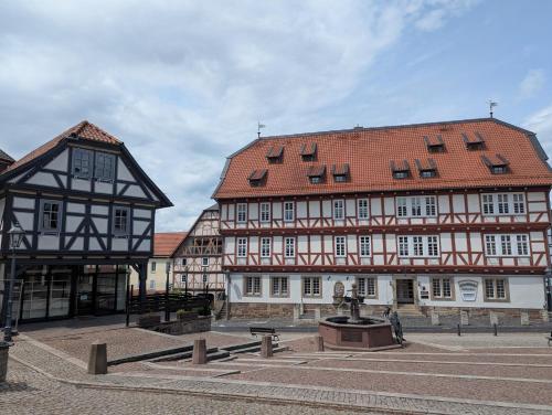 a couple of buildings in a town square at Altes Rathaus Kassel-Wolfhagen in Wolfhagen