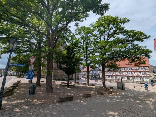 a park with trees and benches on a city street at Altes Rathaus Kassel-Wolfhagen in Wolfhagen