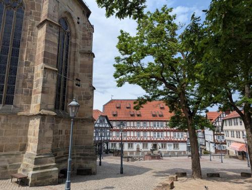 a tree in front of a building in a city at Altes Rathaus Kassel-Wolfhagen in Wolfhagen