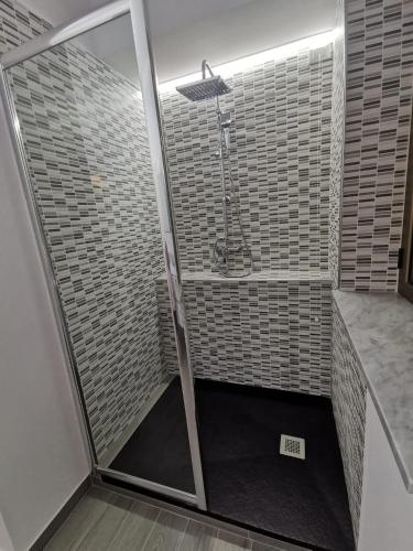 a shower with a glass door in a bathroom at La Maison de Maria en Calabre in Campora San Giovanni