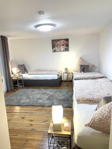 a bedroom with two beds and a table with a lamp at Haus für bis zu 7 Personen in Schwedt Oder Passow in Schwedt