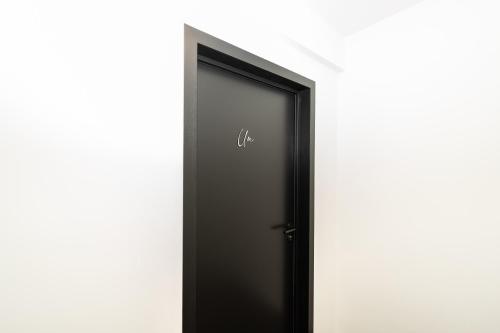 a black elevator door with the number on it at Hôtel de la Poste in Gedinne