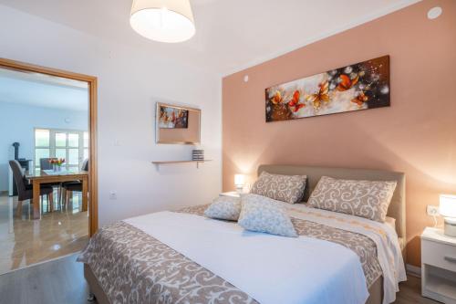 a bedroom with a bed and a dining room at Villa Bonissa, a private and tranquil haven amidst nature in Pićan