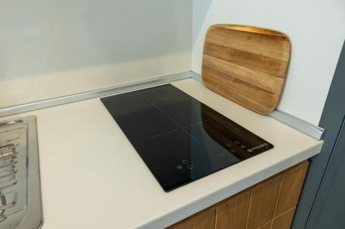 a kitchen with a stove and a cutting board at Onar Luxury Suites Parga in Parga