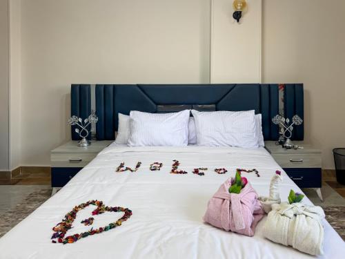 a bed with a group of animals spelled out on it at Luxury Panorama pyramids & jacuzzi in Cairo
