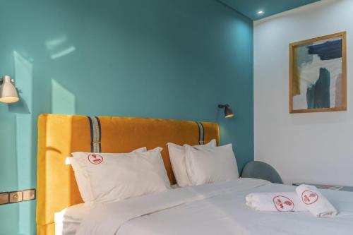 a bedroom with a bed with white sheets and pillows at W hotel in Dakhla
