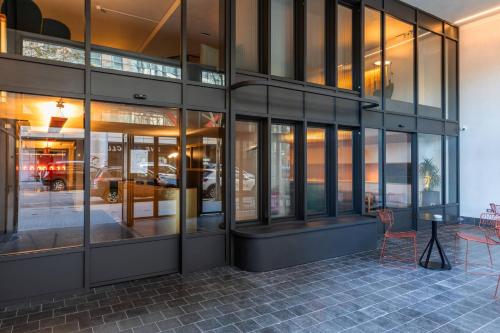 a building with glass windows and a table and chairs at Onix Fira in Barcelona
